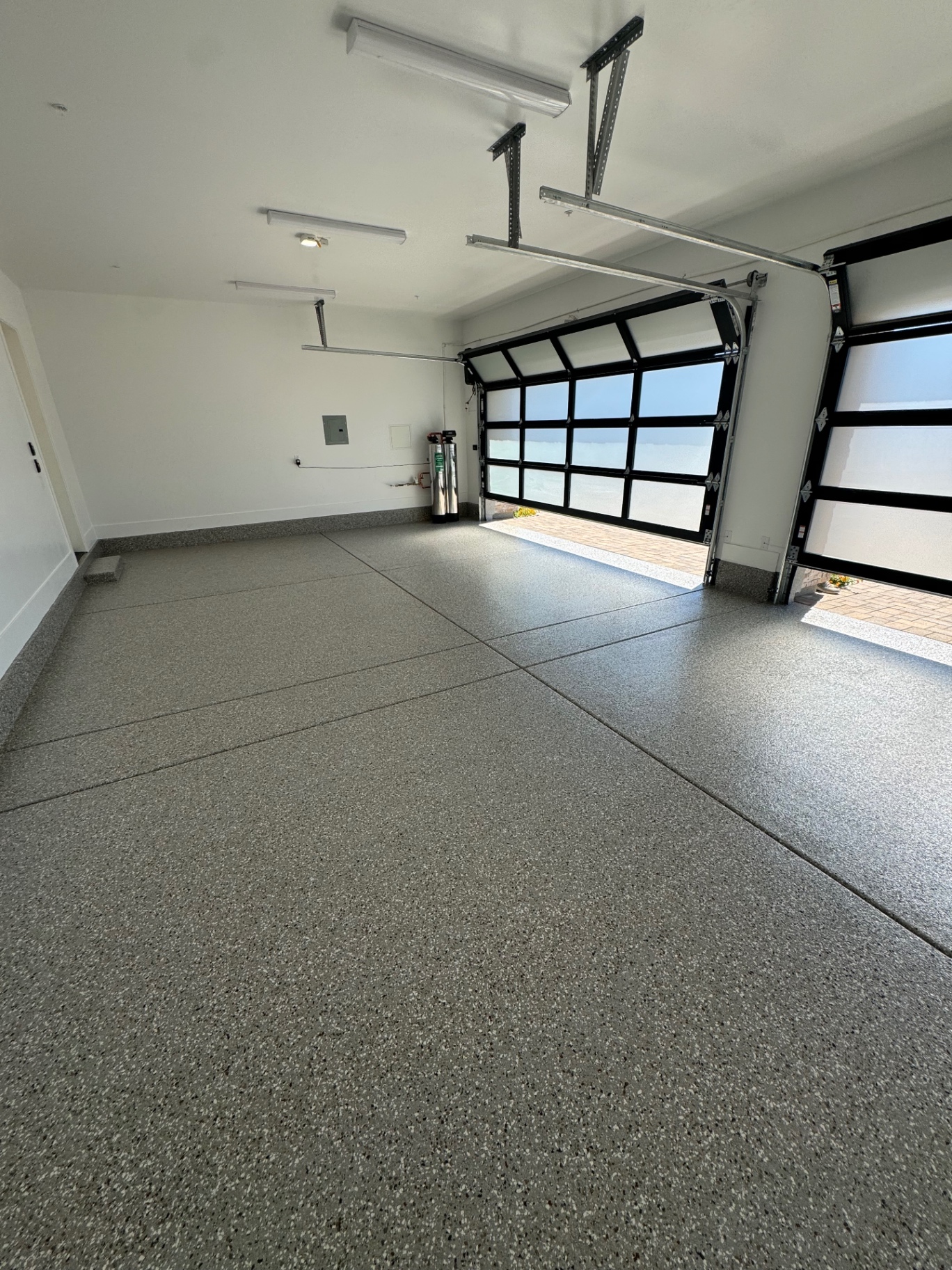 Bright two-car garage with decorative flake floor coating