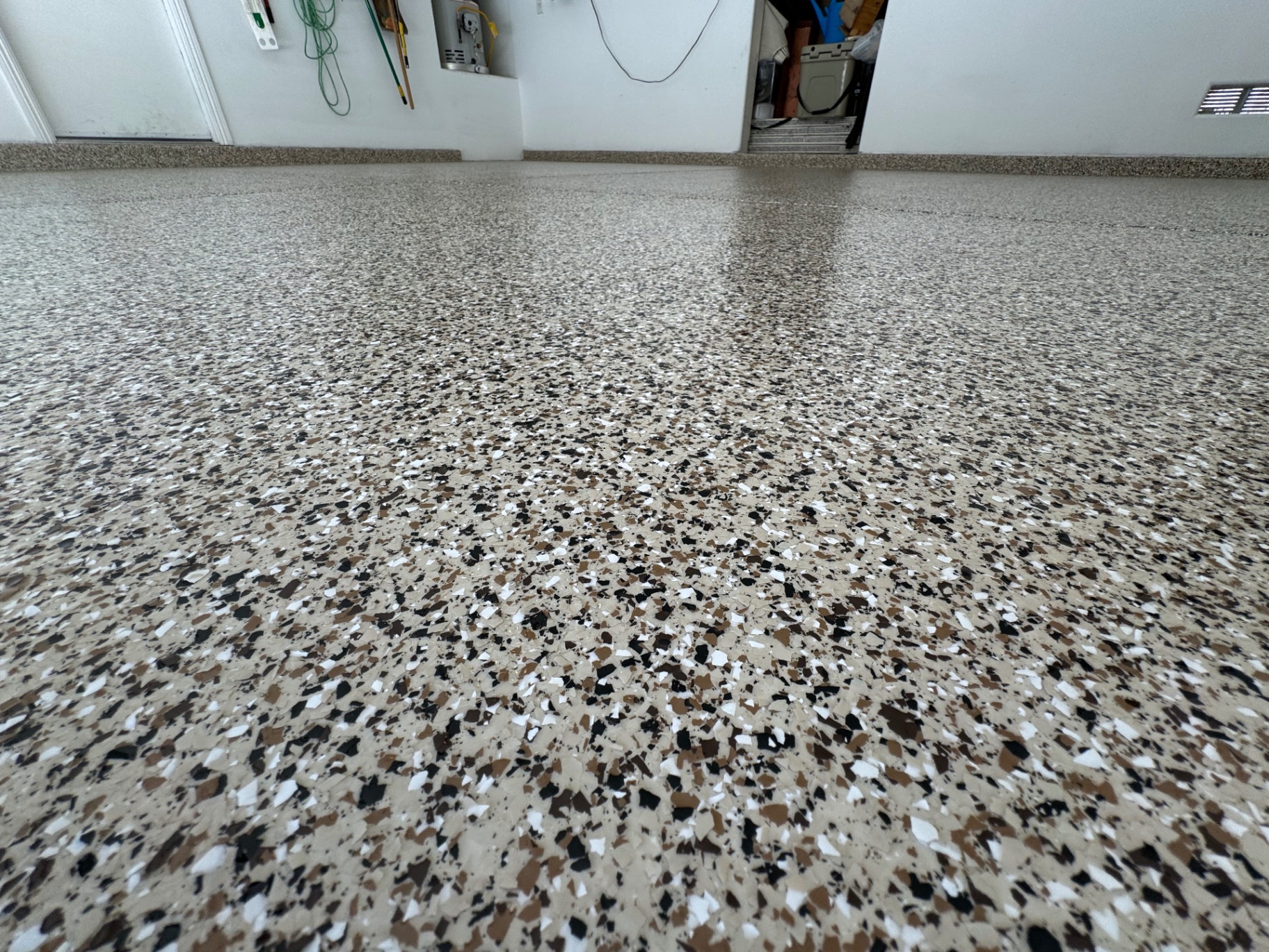 Tan and brown flake garage floor coating in a clean garage