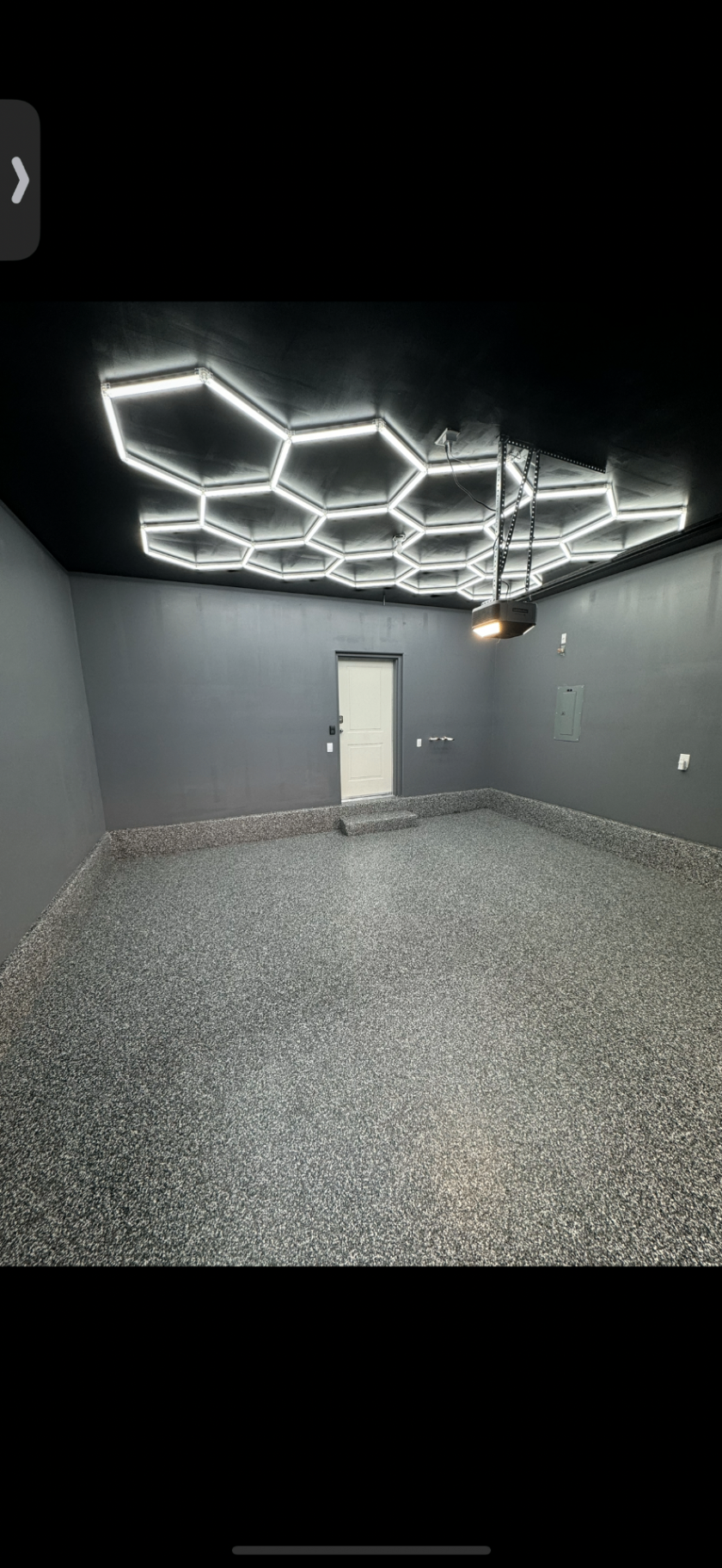 Garage floor with gray flake coating and custom hex ceiling lights
