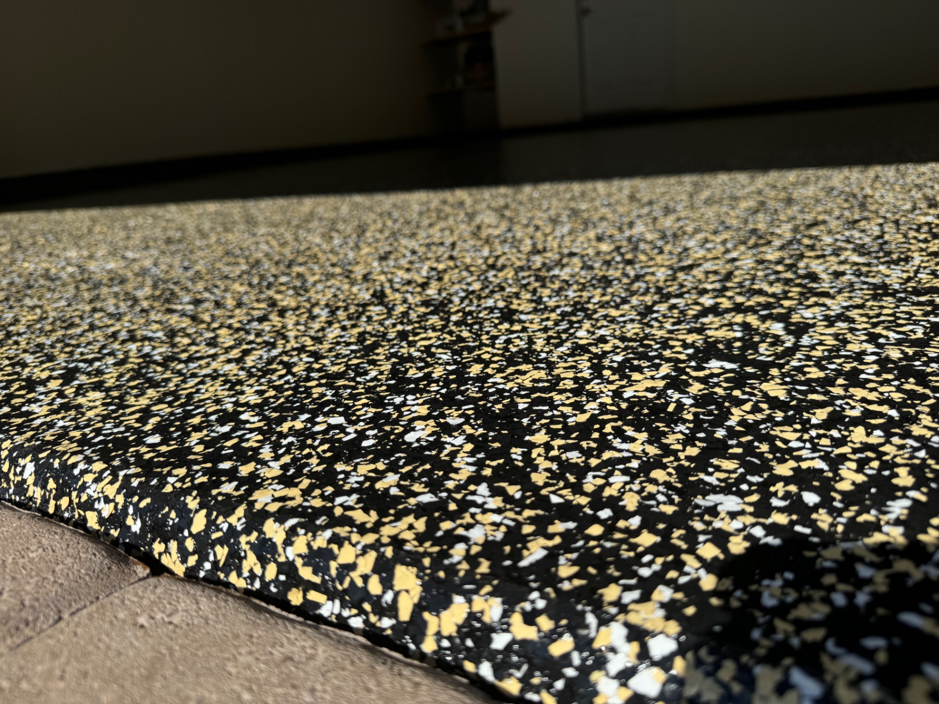 Black and gold flake epoxy floor with a high-gloss topcoat